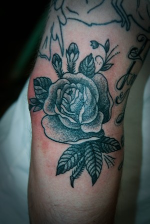 I tattooed this dot work rose this morning on the outside of Eli's elbow